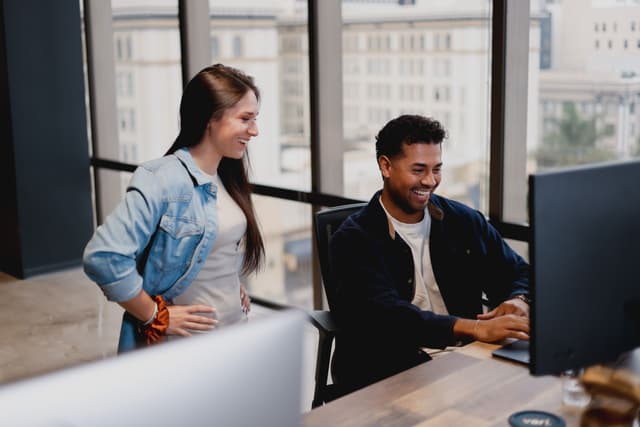 Webstacks employees working at a desktop