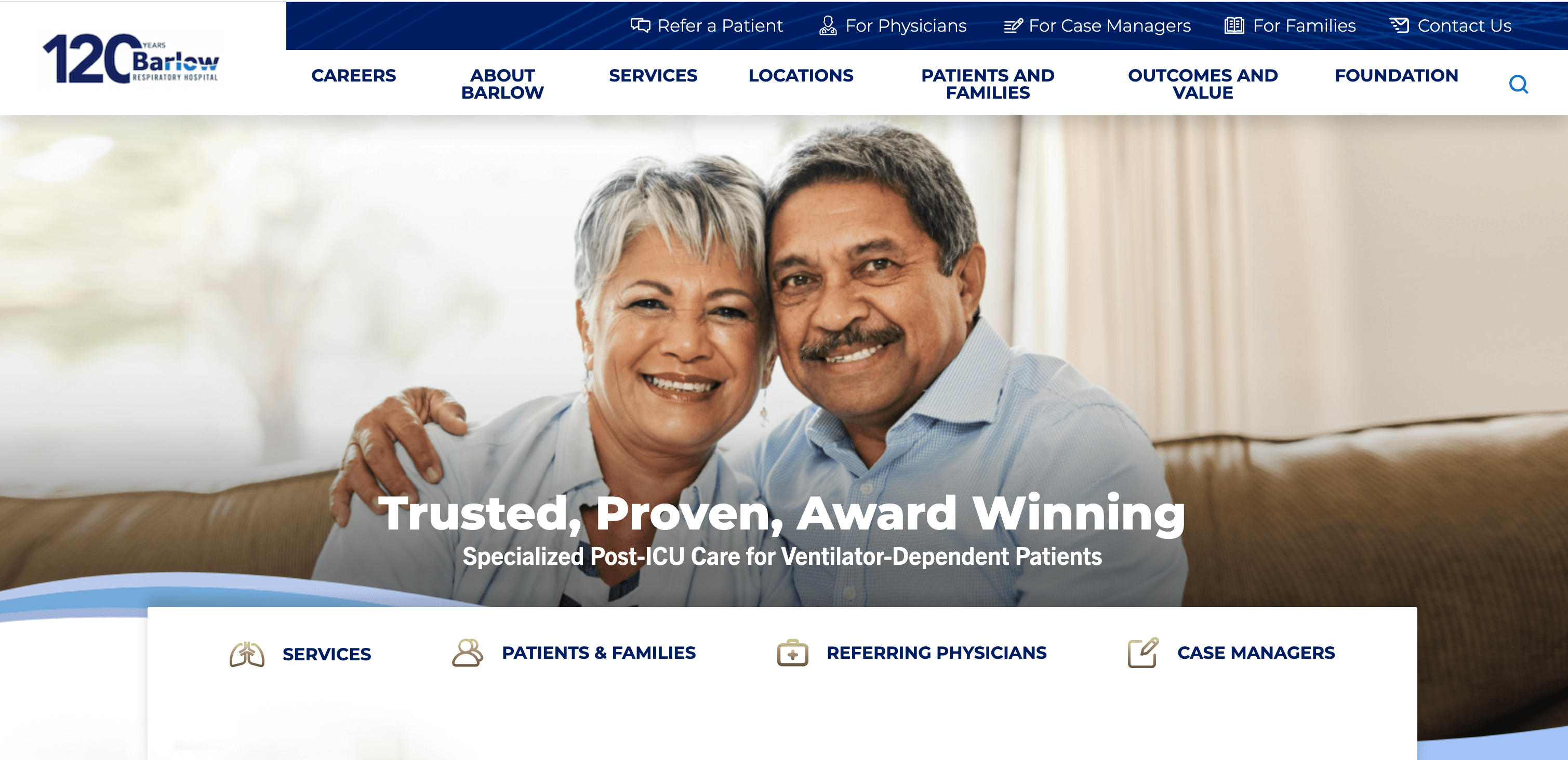 A smiling couple sits together, promoting Barlow Respiratory Hospital's specialized post-ICU care services.