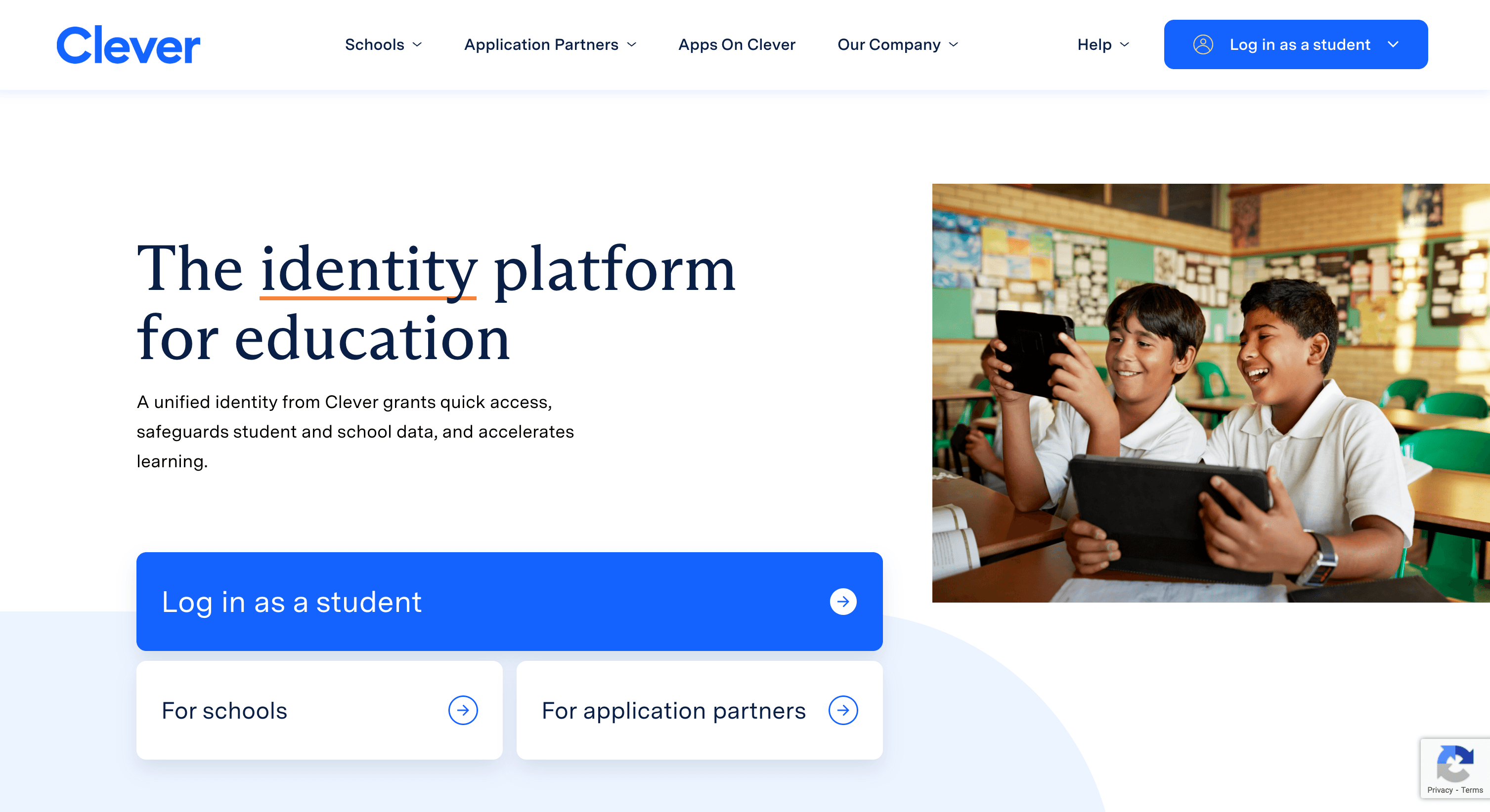 Two students in a classroom smile while using tablets, with "Clever" branding and a login prompt on the screen.