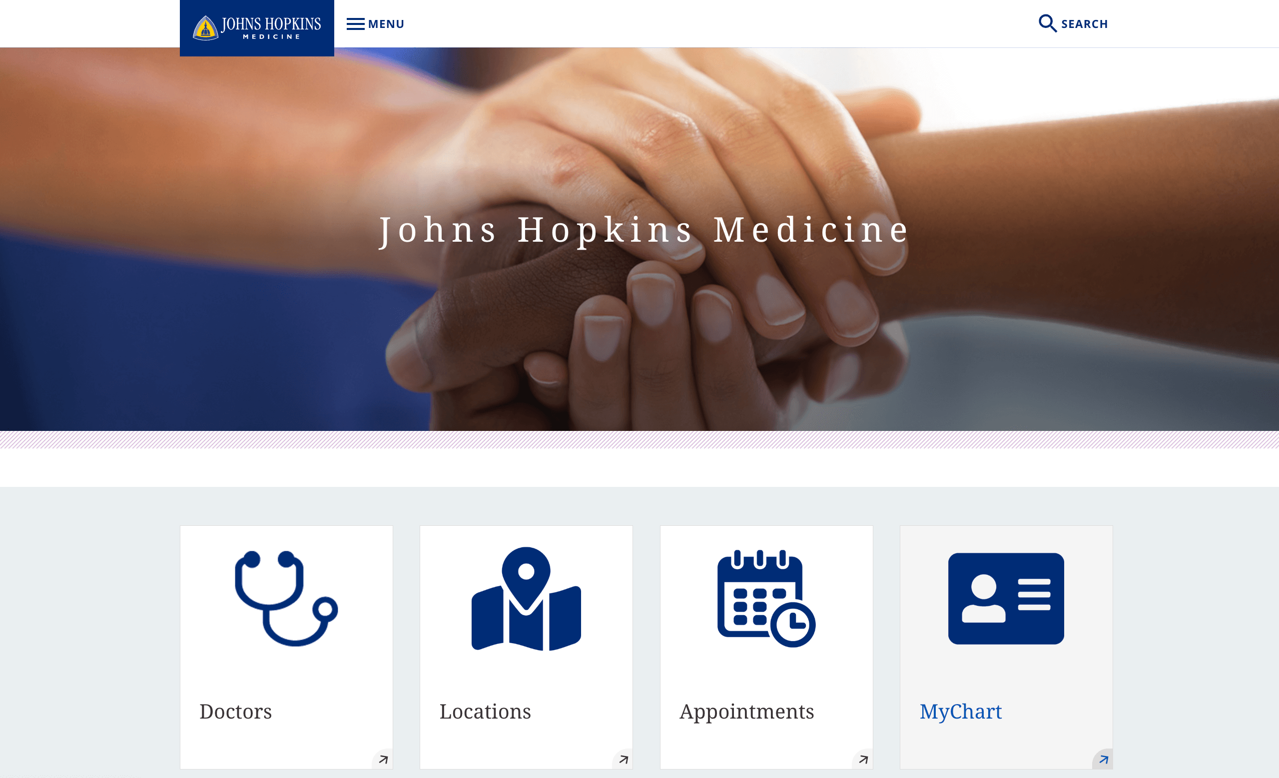 Johns Hopkins Medicine website featuring hands clasped together, emphasizing care and support.
