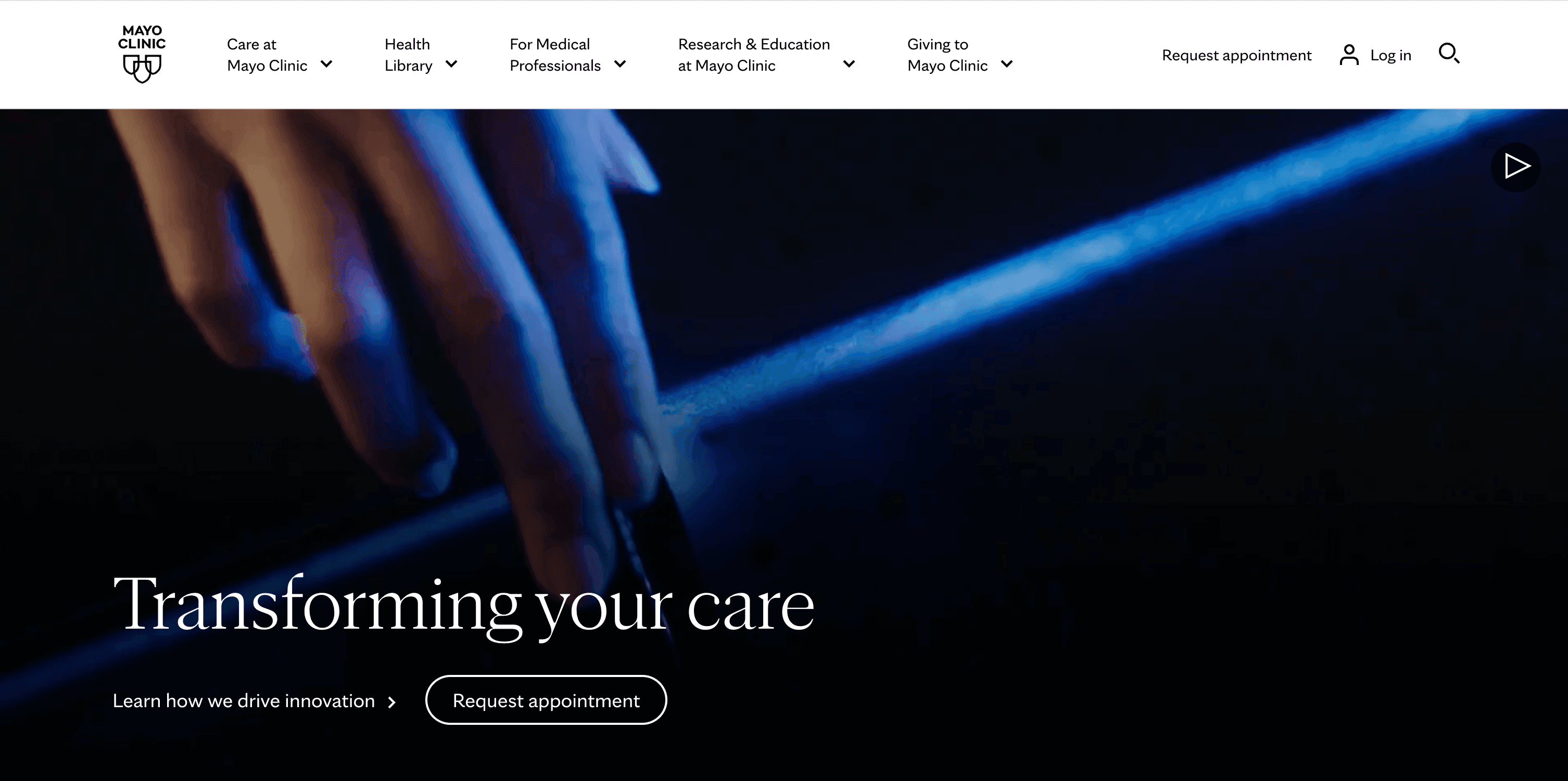 A close-up of a hand reaching towards a glowing blue light, with text about transforming care at Mayo Clinic.