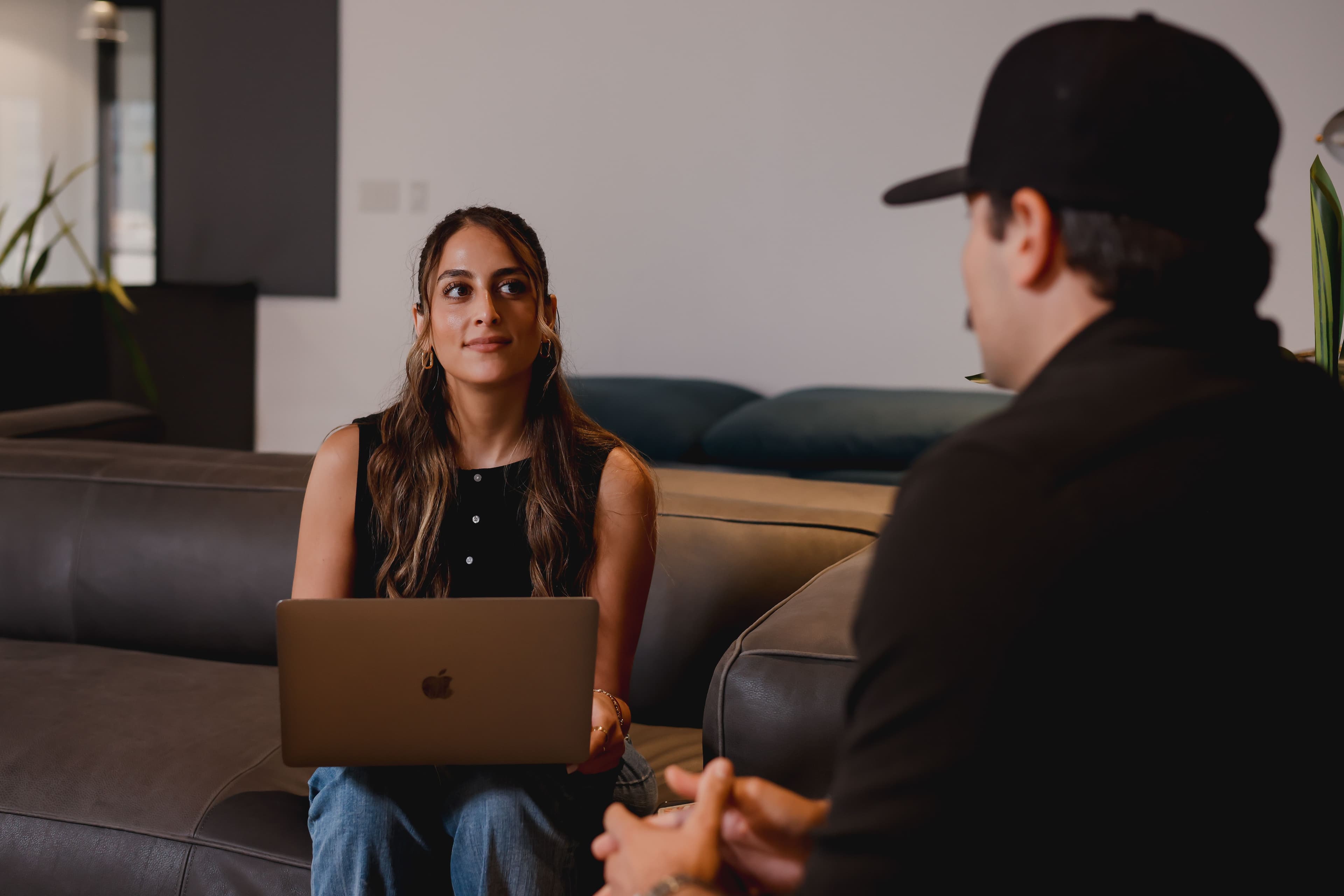Two people talking with laptops