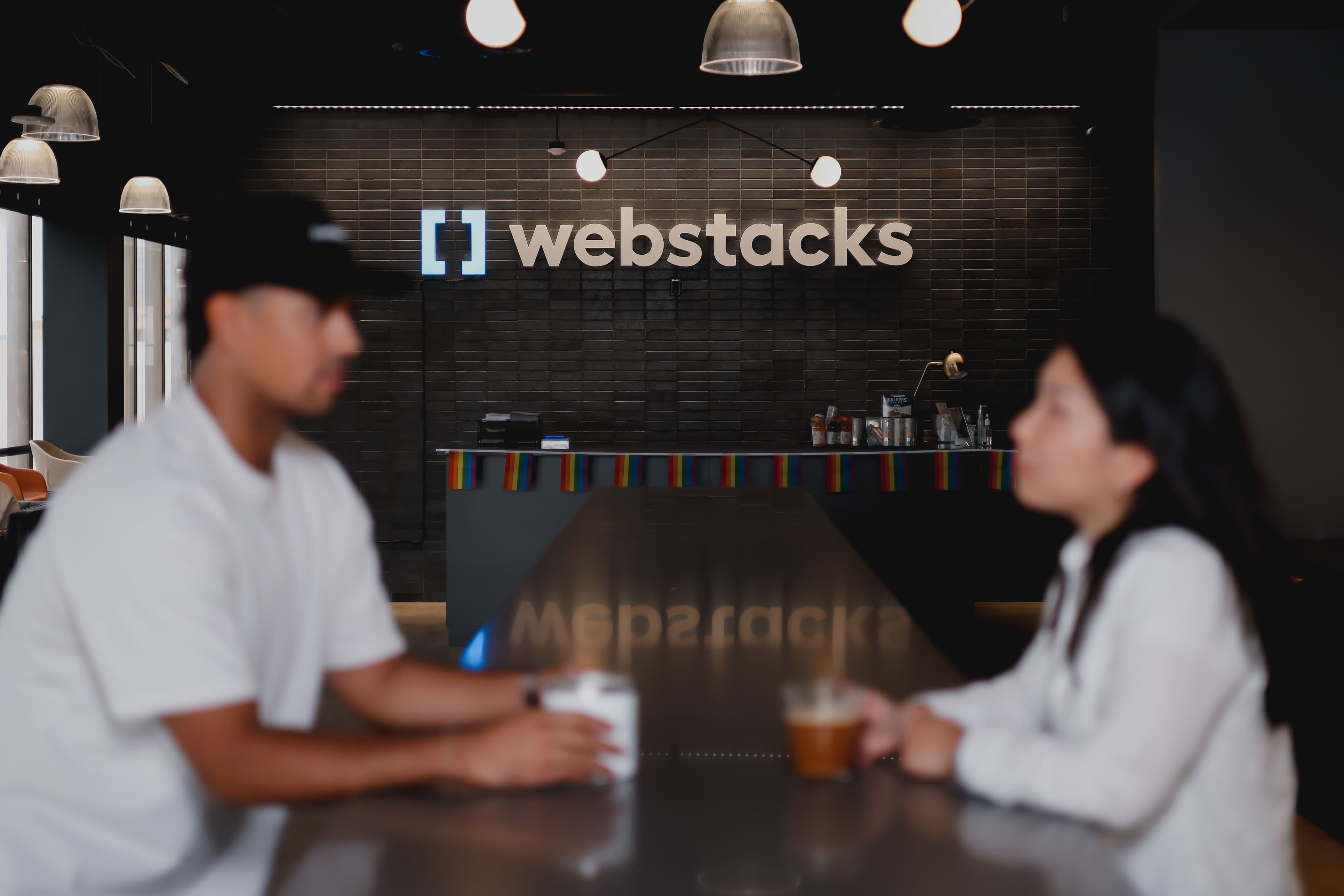 Webstacks employees with Webstacks logo in background