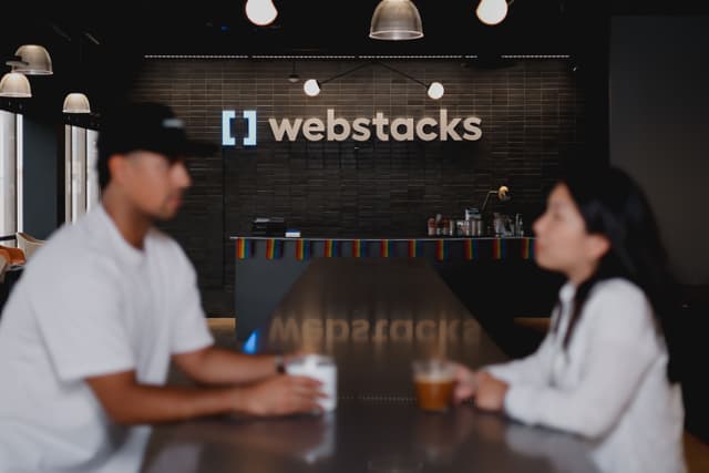 Webstacks employees with Webstacks logo in background