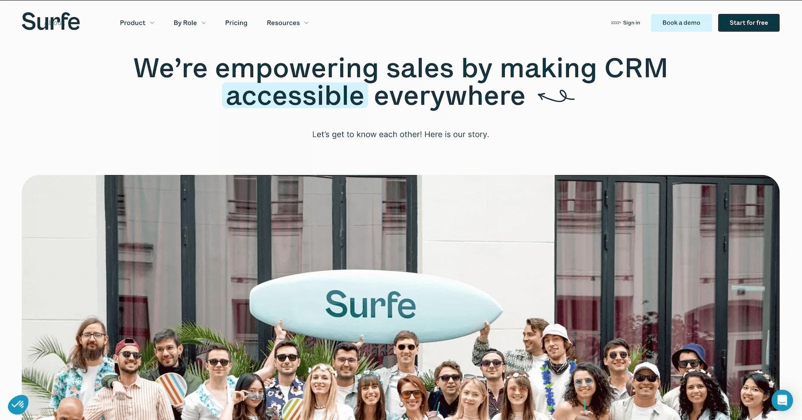 surfe about Group of cheerful people posing with a surfboard labeled "Surfe," promoting CRM accessibility.