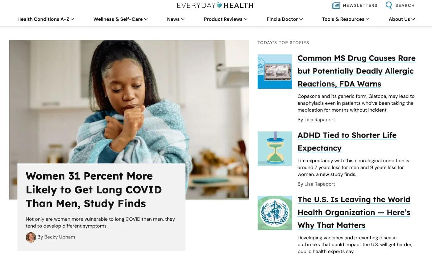 everyday health hp A woman wrapped in a blanket appears concerned while coughing in a bright kitchen setting.