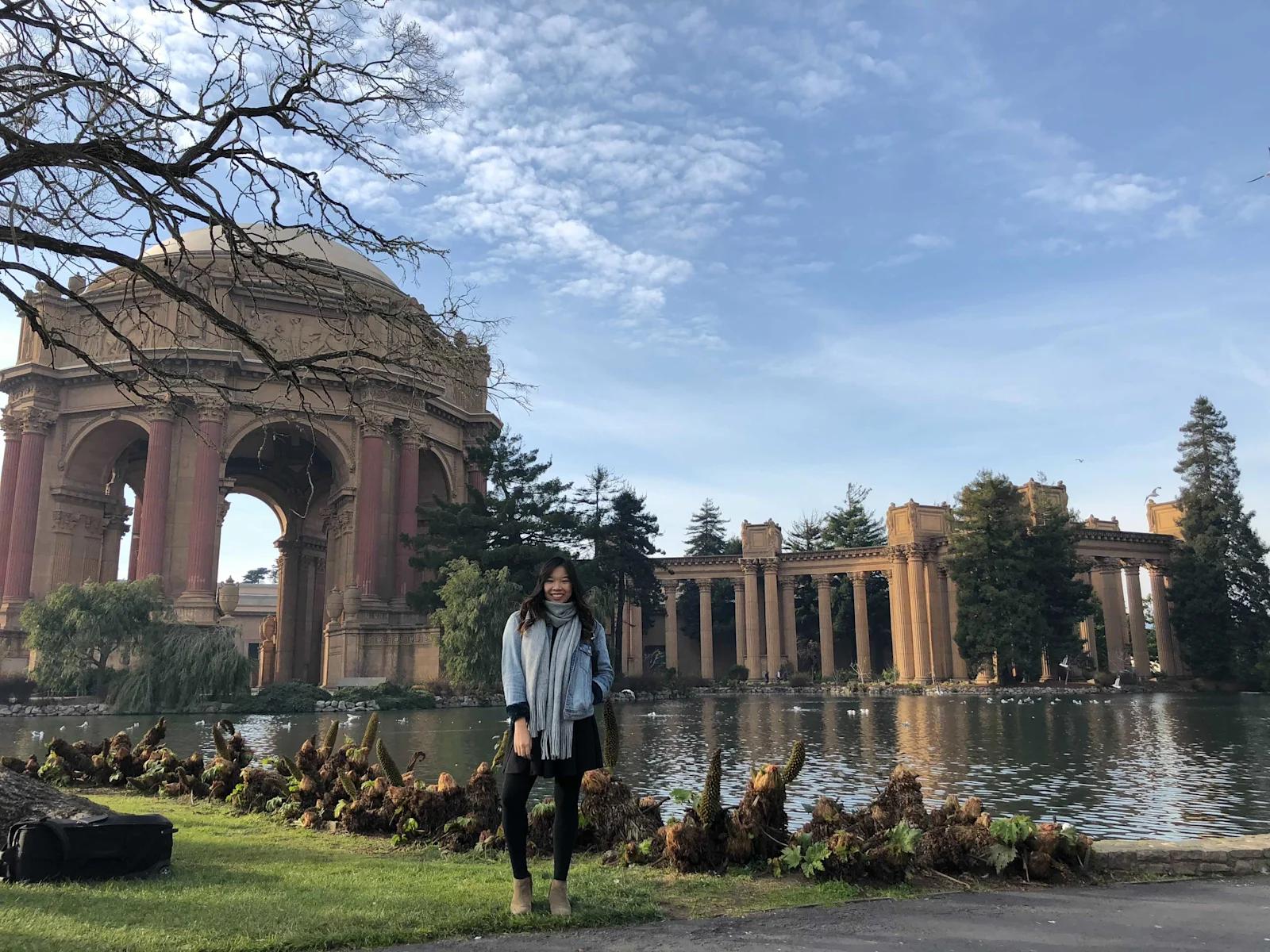 Tracy Yu standing next to a pond.