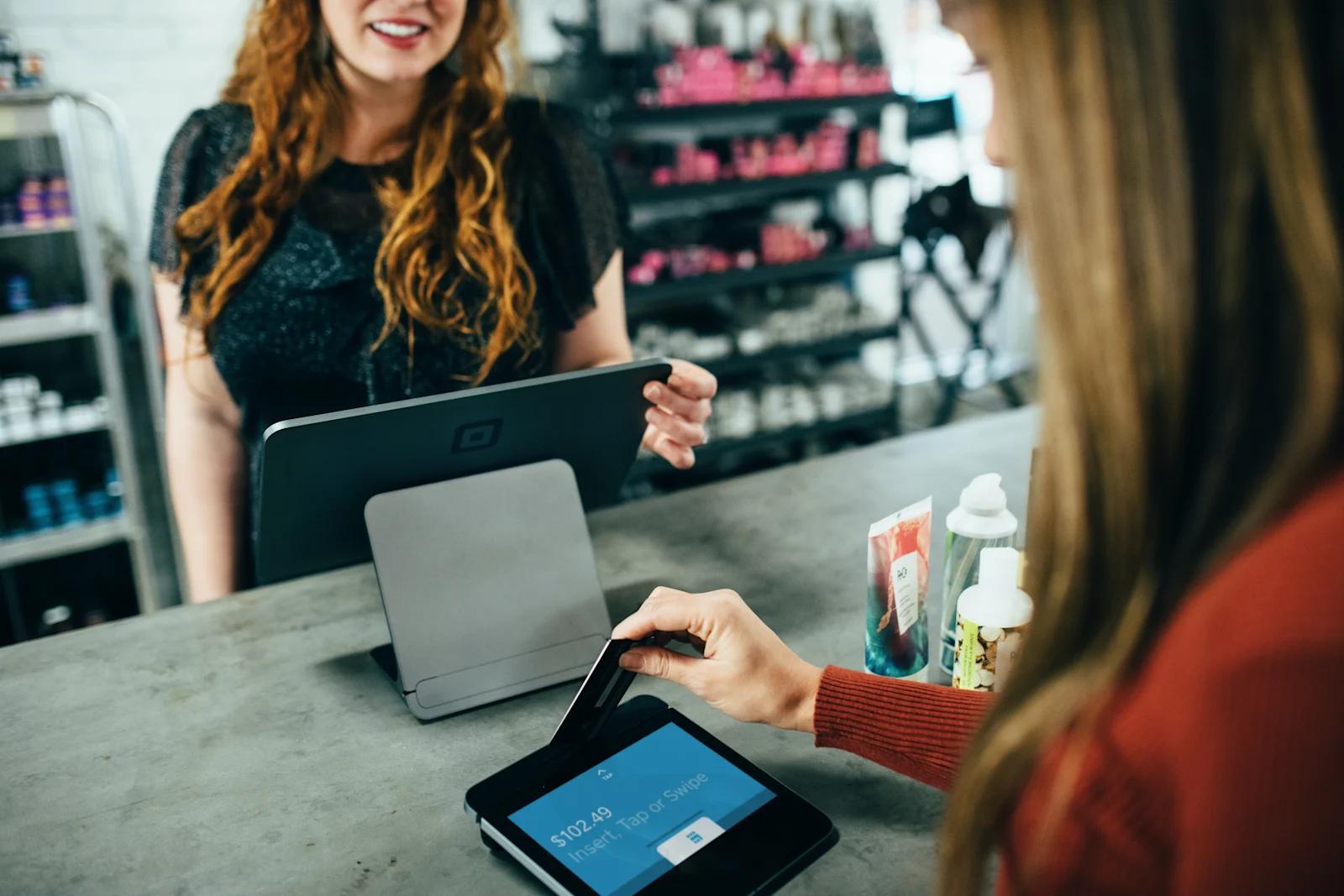 An image of a customer and cashier during a credit card transaction.