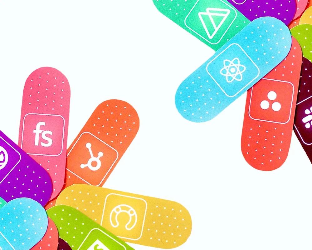 A custom illustration of colorful bandaids representing different technologies.