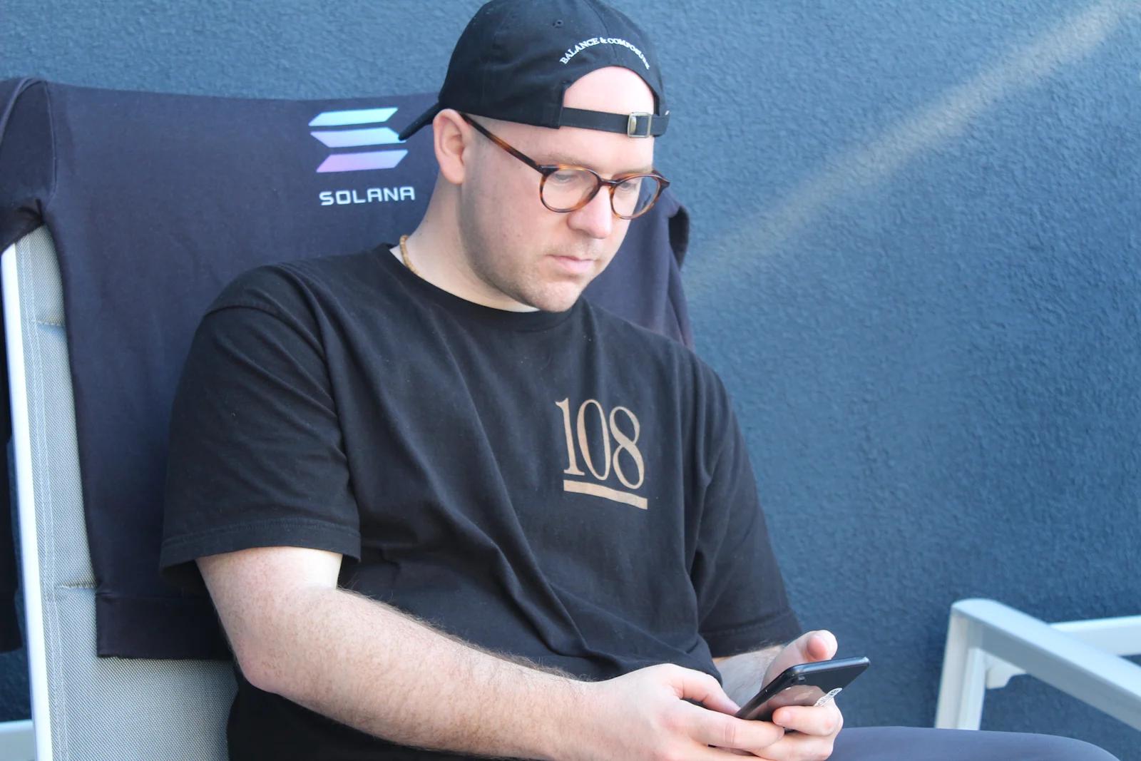 SEO Analyst, Brady Werkheiser checking his iPhone.