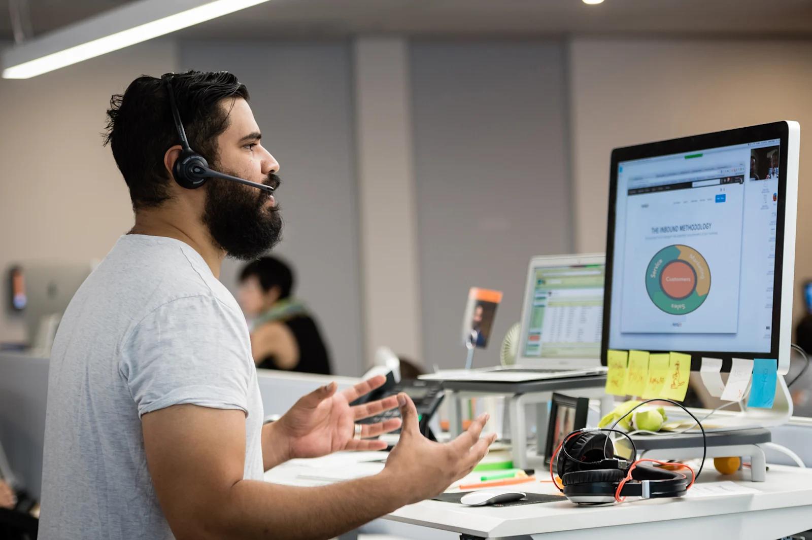 A HubSpot customer support representative sitting at their desk.