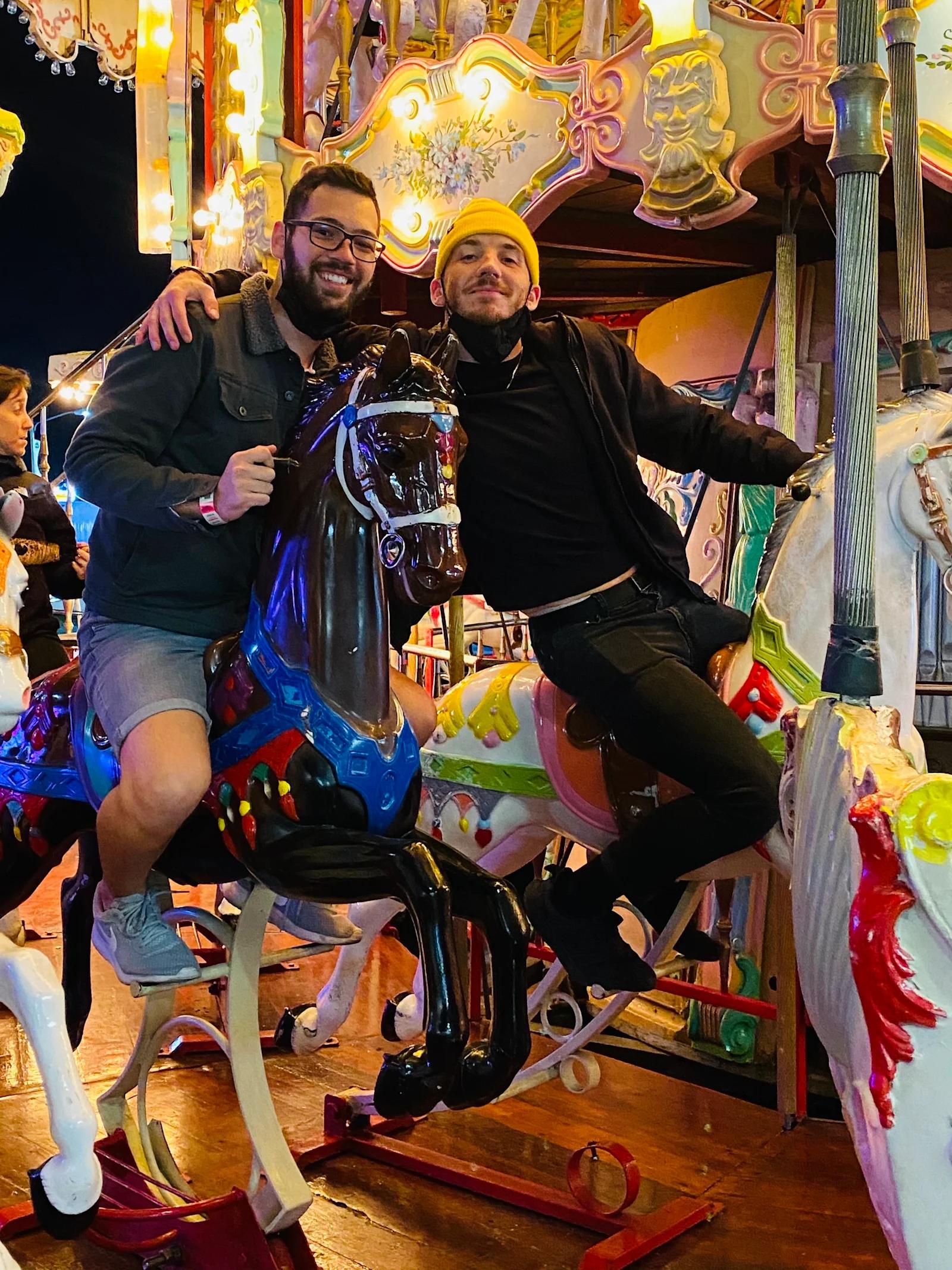 Seric and Alex riding on a carousel.